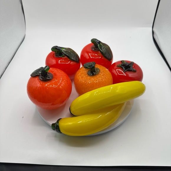 Glass fruit medley oranges apples bananas tomato.Colorful home decor.